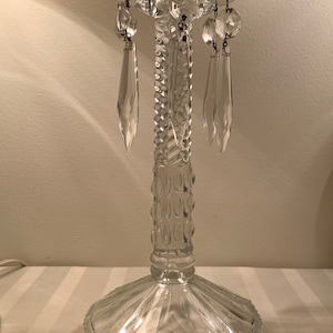 Elegant pair of clear glass candle stick holders with bobeche