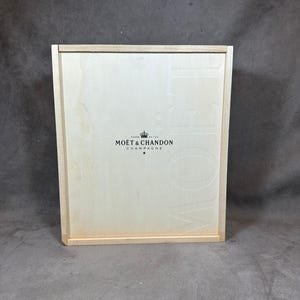 May include: A wooden box with the words "Moët & Chandon Champagne" printed on the front.