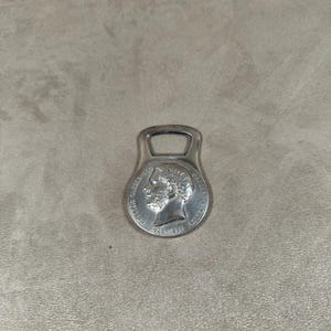 RARE Christofle bottle opener in silver metal with head decoration by Charles Christofle Made in France