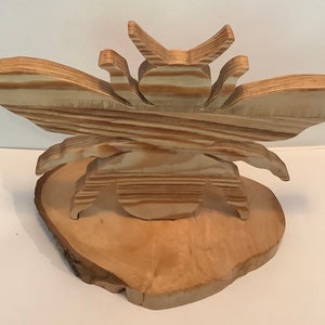 The Wooden Bee, hand crafted out of reclaimed and recycled wood, the Bee is the symbol of Manchester, representing industry and hard work.