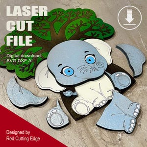 May include: A blue and white elephant puzzle with a green tree. The elephant is made up of multiple pieces, including the head, ears, trunk, legs, and feet. The tree is also made up of multiple pieces, including the trunk and branches. The puzzle is designed for laser cutting.