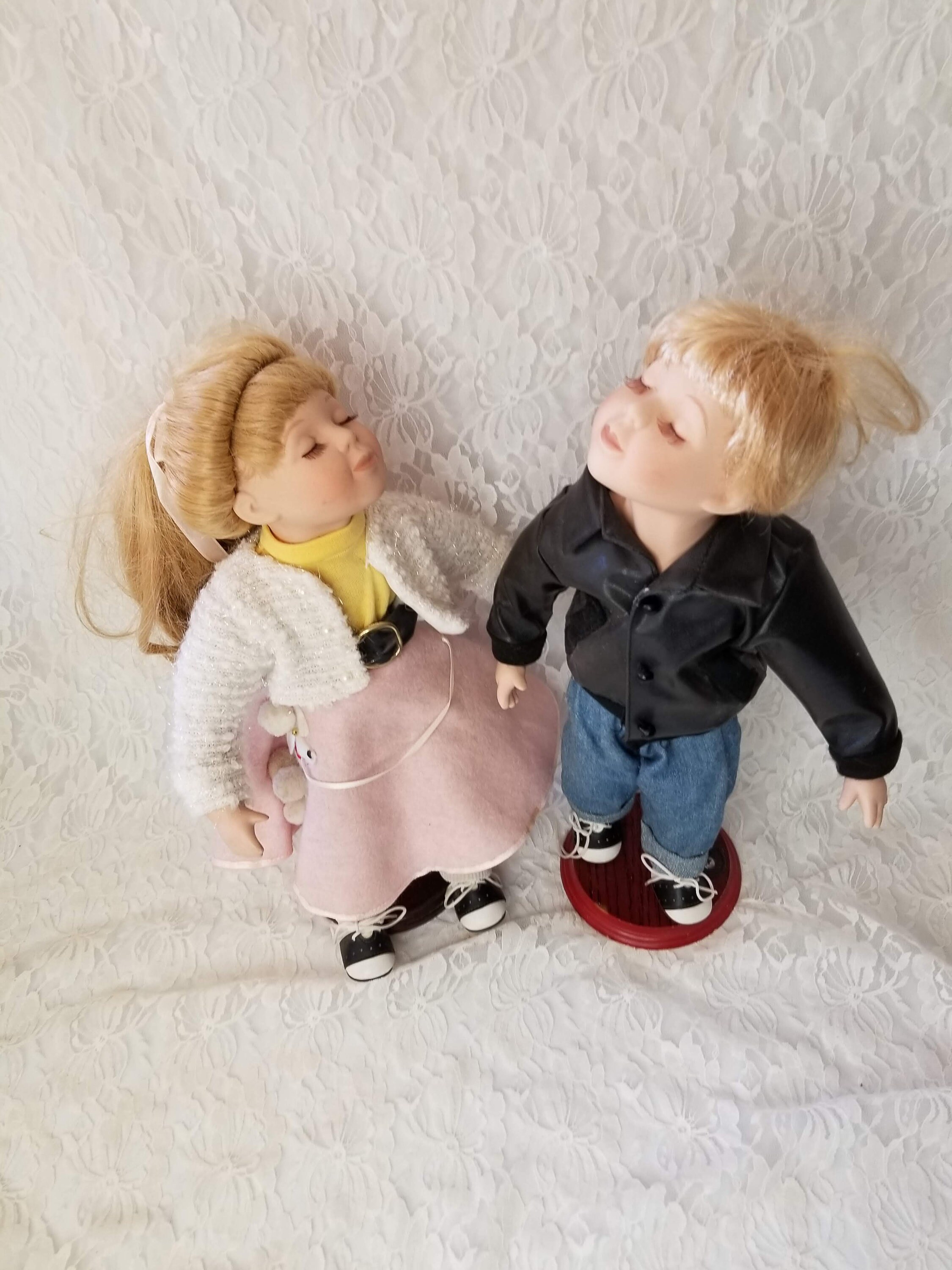 boy and girl kissing porcelain dolls