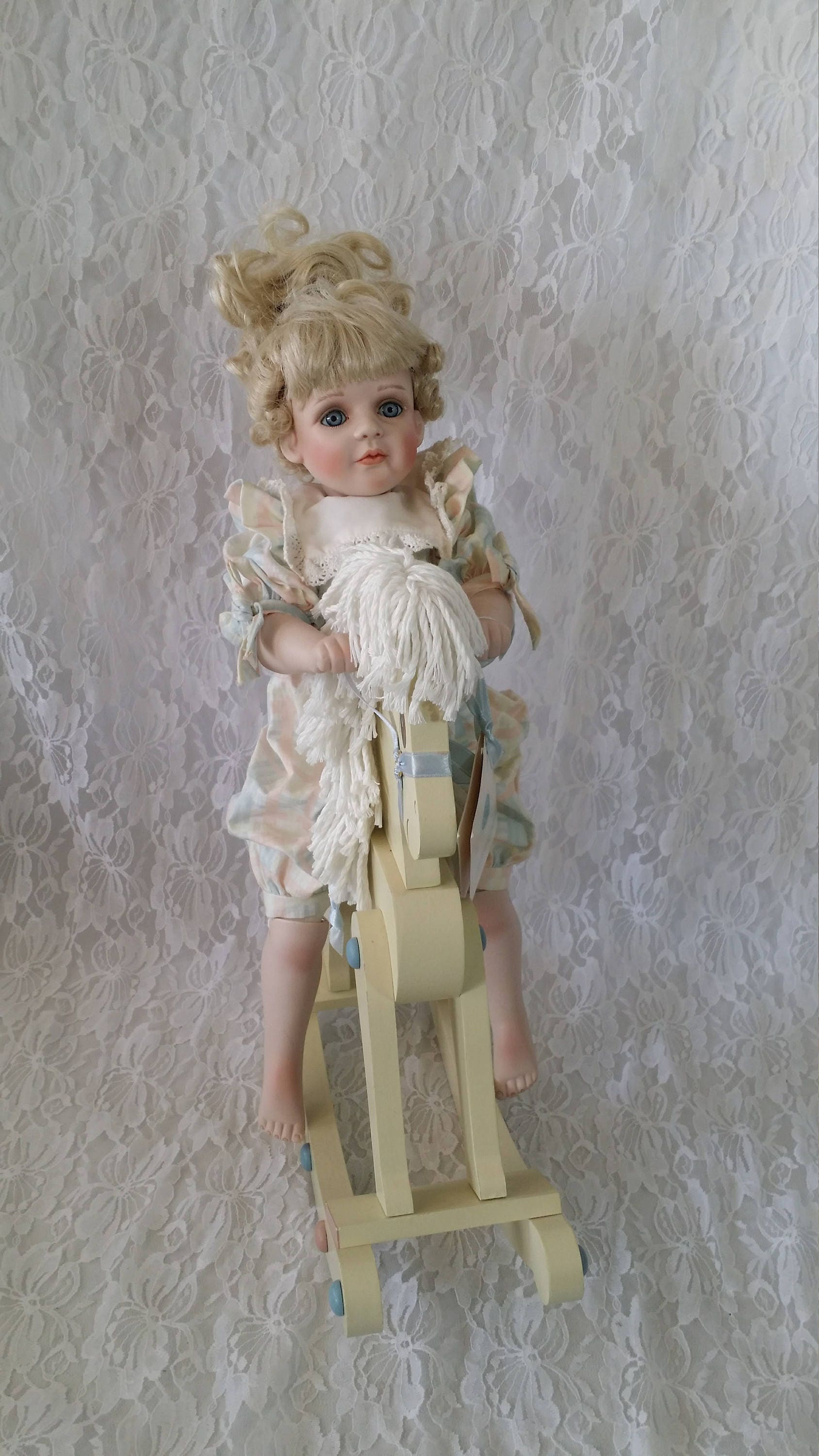 porcelain doll on rocking horse