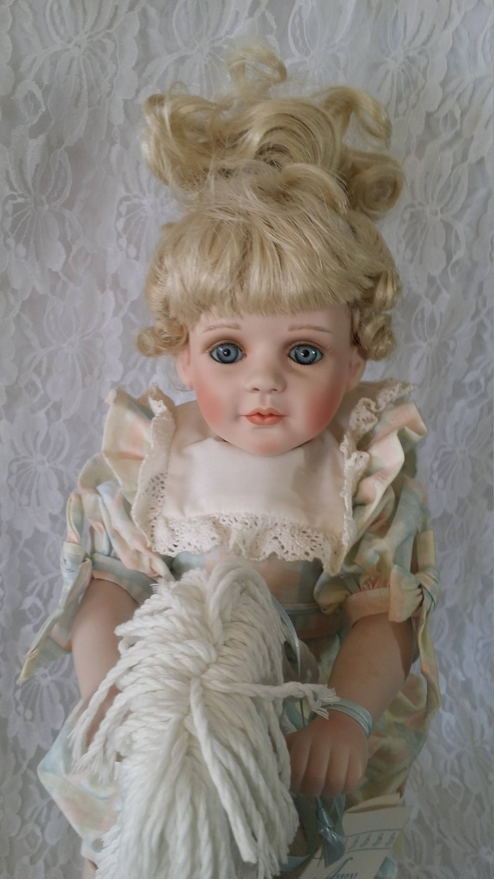 porcelain doll on rocking horse