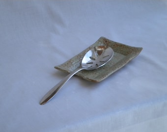 Light green and brown stoneware doily spoon rest
