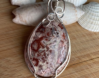 Rosey red Rosetta Stone pendant wrapped in Sterling Silver wire.