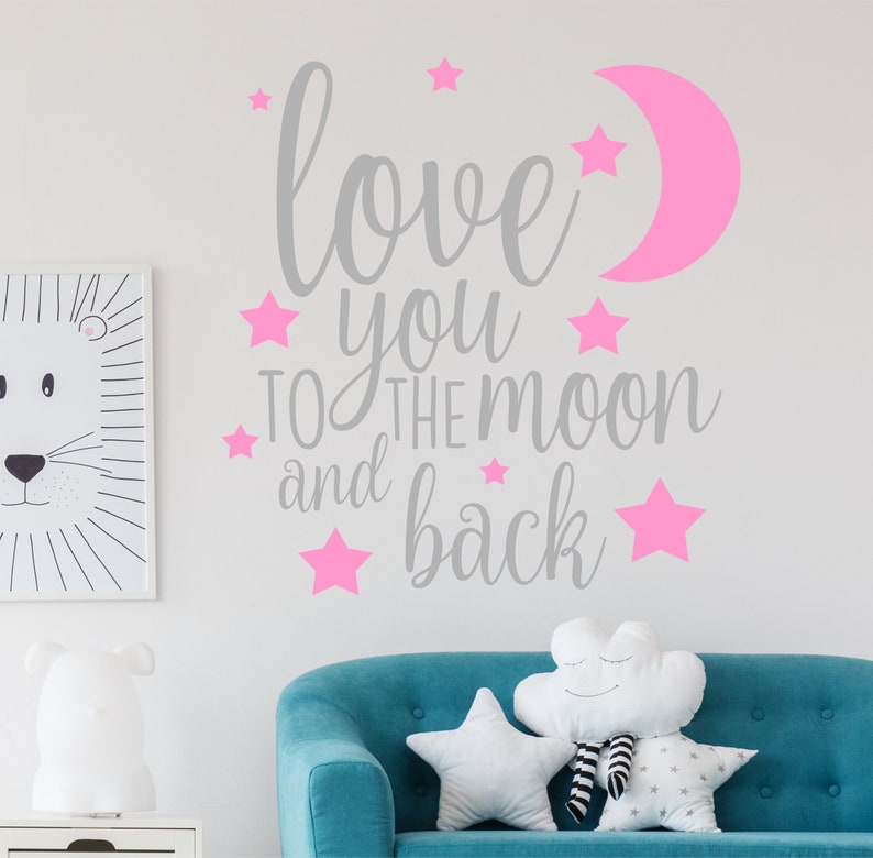 May include: A gray and pink wall decal with the text "love you to the moon and back" surrounded by pink stars and a pink crescent moon.