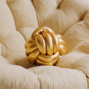 Gold knot pillow on sale