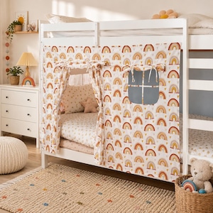 May include: A white bunk bed play tent featuring a repeating pattern of orange, yellow, and brown rainbows and small hearts. The fabric cover includes a roll-up door with tie-backs and a square window cutout, designed to fit the lower bunk frame.