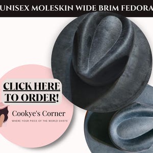 May include: A moleskin fedora hat with a wide brim in a dark gray color. The hat is displayed on a white background. The text "UNISEX MOLESKIN WIDE BRIM FEDORA" is at the top. A pink circle with the text "CLICK HERE TO ORDER!" is in the image.