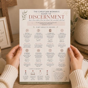 May include: A printed guide titled The Christian Woman's Guide to Discernment, featuring a structured layout with eight key areas to discern, scripture references, and four steps to discern well, printed in black and muted pink text on white paper.