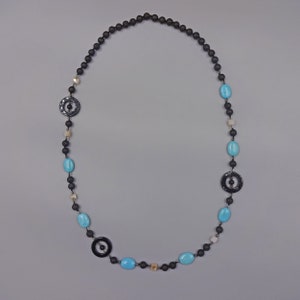 A Long Necklace Features 3 Black Onyx Rings With Matte Onyx And Crystal Beaded Through The Ring