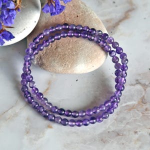 May include: A purple amethyst beaded bracelet with multiple strands of small round beads.
