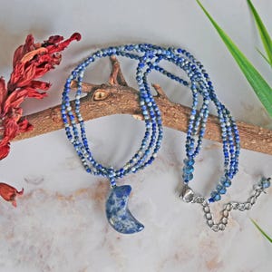 Multi-strand micro cut lapis lazuli necklace with a puff sodalite half-moon pendant.  blue gemstone pendant necklace.