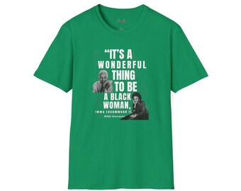 May include: Green t-shirt with a white print that reads "It's a wonderful thing to be a black woman, imma recommend it." - Nikki Giovanni.