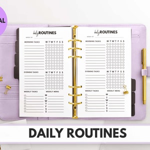 Peut inclure: Un classeur violet avec deux pages blanches ouvertes sur un planificateur de routines quotidiennes. Le planificateur comporte des sections pour les tâches du matin, les tâches du soir, les tâches hebdomadaires et un menu hebdomadaire. Le planificateur est intitulé "routines quotidiennes".
