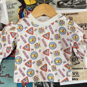 Vintage Baby Girl Kids 80s-90s Bunny Baby Bows Gifts All Over Graphic Print Hopscotch Long Sleeve Ringer T-Shirt Top 0-6 Months
