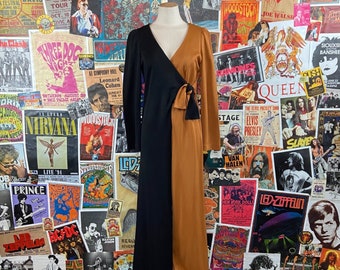 May include: A long-sleeved dress with a black and brown color block design. The dress has a V-neckline and a wrap-style bodice. The dress is made of a smooth, silky fabric.