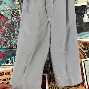 May include: Blue and white striped pajama pants with an elastic waistband and white stitching. The pants are made of a lightweight fabric and have a relaxed fit. The pants are approximately 30 inches long.