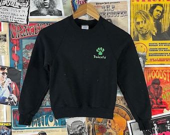 Sudadera infantil vintage de los 90, negra, con estampado de pintura hinchable de los Bobcats, cuello redondo, talla 8, para edades de 7 a 8 años.