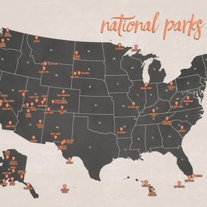 May include: A map of the United States with the words "national parks" in a cursive font. The map is dark gray with orange icons marking the locations of national parks across the country. The background is a light beige color.