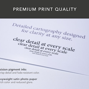 May include: A close-up of a white paper with text that reads "PREMIUM PRINT QUALITY". The text on the paper includes "Detailed cartography designed for clarity at any size" and "clear detail at every scale". The bottom of the paper reads "Precision pigment inks" and "Heavyweight satin photo paper".