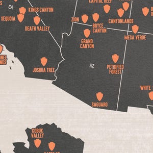 May include: A detailed map of the United States featuring national parks and monuments. The map is in shades of gray with orange icons and text indicating locations like Zion, Grand Canyon, and Death Valley.