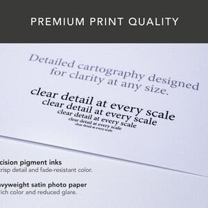 May include: A close-up of a white paper with text that reads "PREMIUM PRINT QUALITY". The text on the paper includes "Detailed cartography designed for clarity at any size" and "clear detail at every scale". The bottom of the paper reads "Precision pigment inks" and "Heavyweight satin photo paper".