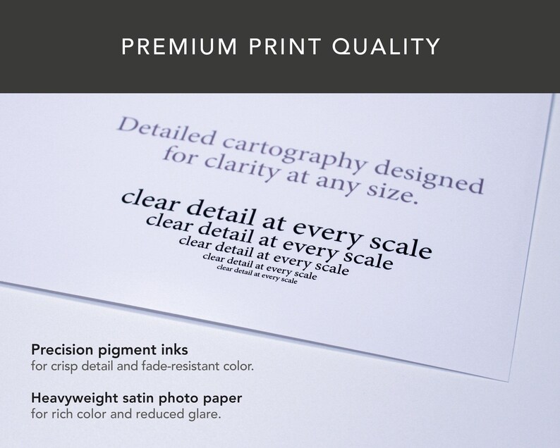 May include: A close-up of a white paper with text that reads "PREMIUM PRINT QUALITY". The text on the paper includes "Detailed cartography designed for clarity at any size" and "clear detail at every scale". The bottom of the paper reads "Precision pigment inks" and "Heavyweight satin photo paper".