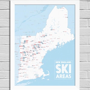 May include: Framed map of New England ski areas. The map is white with a light blue background and features red and blue icons indicating ski resorts. The words "New England Ski Areas" are in white block letters.