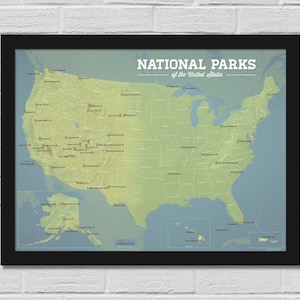 May include: A framed map of the United States, highlighting National Parks. The map is in shades of green and yellow, with park locations marked. The title "NATIONAL PARKS of the United States" is displayed in white text at the top. The frame is black.