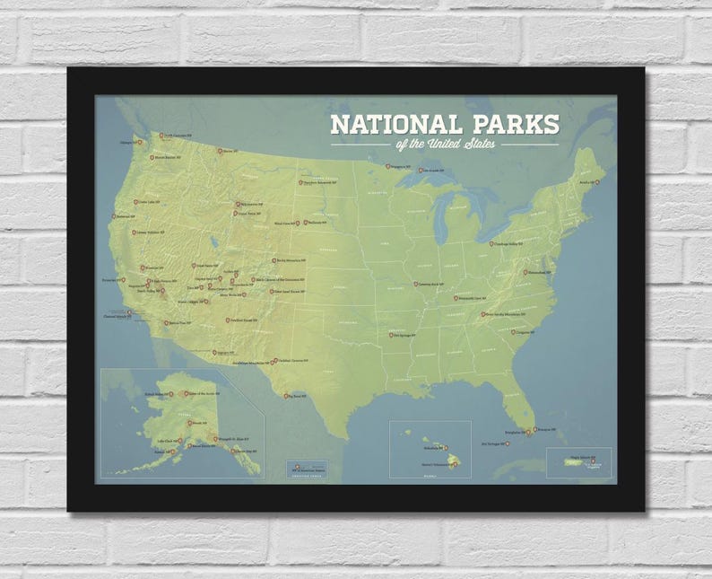May include: A framed map of the United States, highlighting National Parks. The map is in shades of green and yellow, with park locations marked. The title "NATIONAL PARKS of the United States" is displayed in white text at the top. The frame is black.