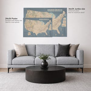 May include: Two posters of the United States map, one 24x36 inches and the other 36x54 inches, are displayed on a wall. The posters are in a muted color palette with text that reads "National Park System National Forest System". The posters are above a gray sofa.