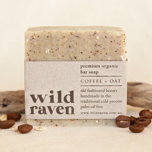 May include: A bar of coffee and oat soap from Wild Raven. The soap is handmade using the traditional cold process and is palm oil free. The label is brown with white text and the soap is a light brown colour.