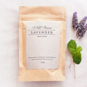 May include: A brown paper pouch with a white label that reads "Wild Raven Lavender Bath Salts" and "hand crafted all natural, herbal body care www.wildravensoap.etsy.com 175g".