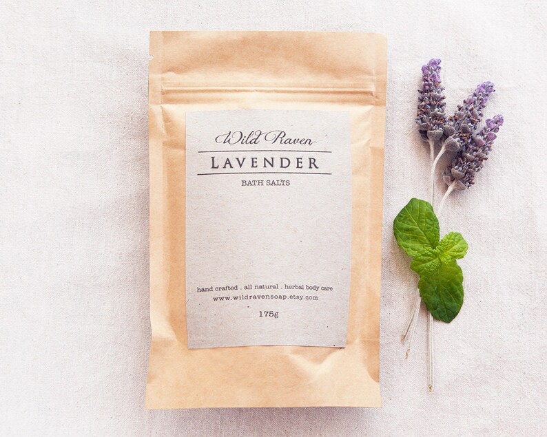 May include: A brown paper pouch with a white label that reads "Wild Raven Lavender Bath Salts" and "hand crafted all natural, herbal body care www.wildravensoap.etsy.com 175g".