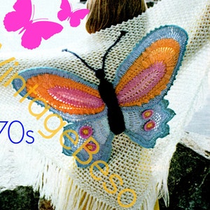 May include: A white crocheted shawl with a large crocheted butterfly design on the back. The butterfly is blue, orange, and pink. The shawl has fringe around the edges. 1970s.