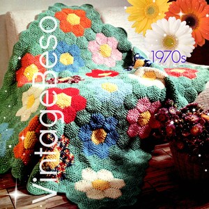 May include: A crocheted blanket with a floral pattern in shades of green, blue, pink, red, yellow, and white. The blanket is folded over a couch and has a scalloped edge. The text "1970s" is visible in the image.