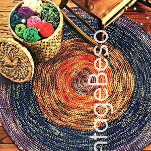 May include: A colorful crocheted rug with a circular design in shades of blue, orange, and purple. The rug is on a wooden floor and there is a rocking chair with a crocheted cushion in the background. The text "1970s" is visible in the lower left corner of the image.