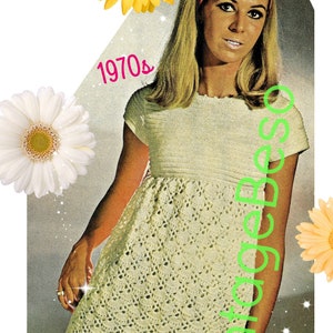 May include: A vintage 1970s crochet dress pattern featuring a white crochet dress with a round neckline and short sleeves. The dress has a fitted bodice and a flowing skirt. The model is wearing a headband and has long blonde hair.