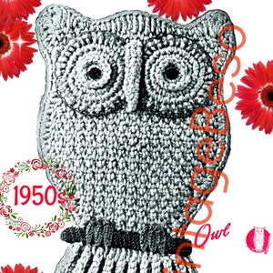 May include: A black and white knitted owl with a brown band around its neck. The owl is surrounded by red flowers.
