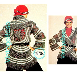May include: Vintage 1970s crochet jacket pattern. The jacket is gray with white stripes and fringe, featuring a red square design on the back. The model is wearing a red hat and a black belt. The text "Vintage Beso" and "1970s" are visible.