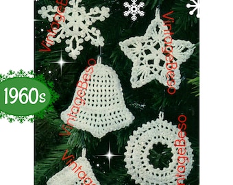 Peut inclure: Cinq décorations de Noël blanches en crochet accrochées à un sapin de Noël vert. Les décorations sont un flocon de neige, une étoile, une cloche, une couronne et une chaussette.