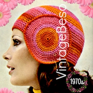 May include: A vintage crochet hat with a pink and orange striped design. The hat has a round, circular top and a wide brim. The hat is from the 1970s.