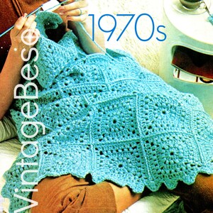 May include: A teal crochet blanket with a square pattern. The blanket is draped over a person's lap. The text "1970s" is written in blue letters above the blanket.
