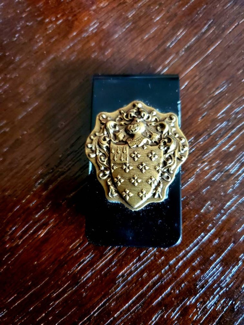 Royalty Heraldry logo black money clip with brass knight and she Royalty Heraldry logo black money clip with brass knight and she