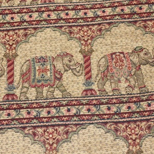 May include: Beige fabric with a repeating pattern of elephants, arches, and floral designs in shades of red, blue, and green.