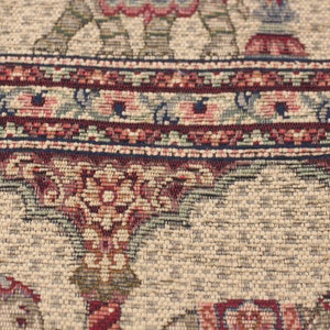 May include: Close-up of a beige rug with a detailed floral pattern in shades of red, blue, and green. The rug has a woven texture and intricate details.