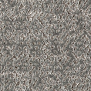 May include: A close-up of a textured fabric with a repeating pattern of small, white squares and brown lines. The fabric has a slightly rough, almost fuzzy texture.