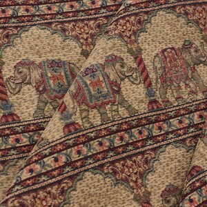 May include: Beige fabric with a repeating pattern of elephants and floral designs in shades of red, blue, and green.